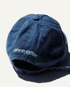 This classic cap is embroidered with the location of our first shop and neighborhood we call home — Echo Park. Canyon tested and approved for roasting, drinking coffee, cooking, hiking, road trips, beaches, and picnics.In a washed navy cotton with an adjustable size. The Canyon Coffee logo is subtly embroidered on the back. Product Details: - Washed Navy Color- Adjustable size Coffee Shop Merch, Canyon Coffee, Varsity Jacket Outfit, Cap Store, Coffee Subscription, Coffee Logo, Drinking Coffee, Jacket Outfit, Echo Park