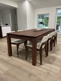 a dining room table and chairs in front of a sliding glass door