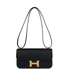 This Hermes Constance Elan is in Black epsom leather with gold hardware, featuring tonal stitching, metal "H" snap closure, and an adjustable strap.The interior is lined in Black lambskin leather and has two open pockets on the front wall, a removable mirror, and a slit pocket on the back wall.Collection: BOrigin: FranceCondition: New and never worn (plastic on hardware) Accompanied by: Hermes box, dustbag, felt, carebook and ribbonMeasurements: 9" width x 5.1" width x 2" depth; 20" adjustable s Constance Hermes, Hermes Birkin 25, Front Wall, Hermes Constance, Hermes Box, Birkin 25, Hermes Birkin, Lambskin Leather, Gold Hardware