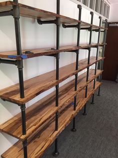 the shelves are made out of wood and metal pipes