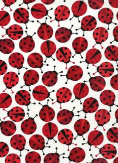 red and black ladybugs on white fabric with small holes in the middle,