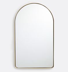 an arched mirror with a gold frame