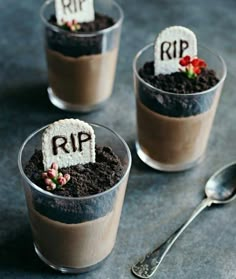 three desserts in small cups decorated with fake tombstones