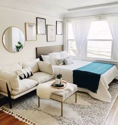 a living room with a couch, bed and ottoman