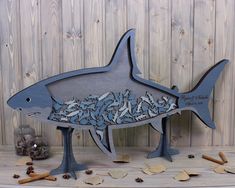 a metal shark sculpture sitting on top of a wooden table