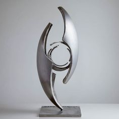 a metal sculpture sitting on top of a white table