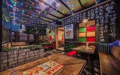 the interior of a chinese restaurant with colorful lights on the ceiling and tables in front