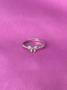 A stunning ring featuring a ribbon bow tie with sparkly cubic zirconia stones. - Water resistant - 925 sterling silver - Will not rust or tarnish - Select desired size at checkout Bow Tie Ring, Cute Promise Rings, Ribbon Bow Tie, Tie Ring, Present Birthday, Silver Ribbon