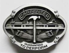 a metal belt buckle with an image of a hammer and wrench in the center