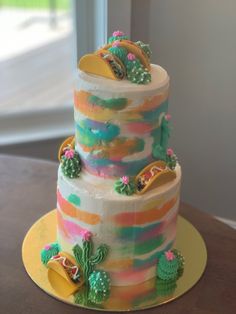 a multi - layered cake decorated with cactus and succulents