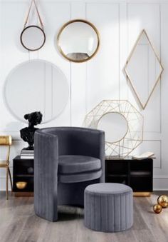 a living room filled with furniture and gold accents on the walls, along with round mirrors