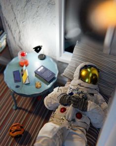 an astronaut doll is sitting on a couch