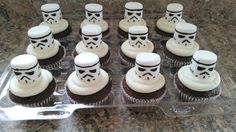 cupcakes with white frosting decorated as stormtrooper's and faces