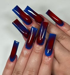 a woman's hands with red and blue nail polishes on their fingertipss