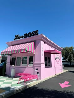 a pink diner with awnings on the roof