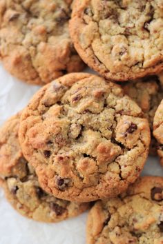 chocolate chip cookies are piled on top of each other