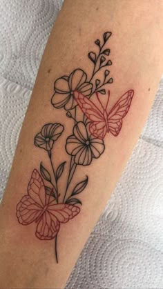 a tattoo with flowers and butterflies on it