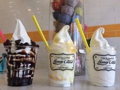 three ice cream sundaes sitting on top of a counter