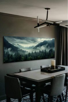 a painting hanging on the wall above a dining room table with chairs and a candle