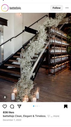 the stairs are decorated with white flowers and candles