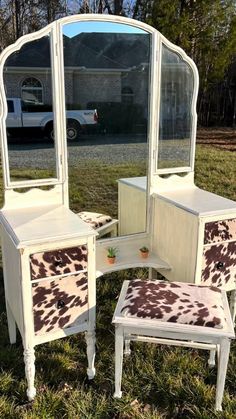 an old vanity and stool are sitting in the grass