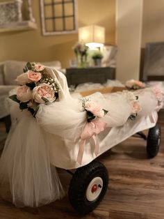 a wedding carriage is decorated with flowers and tulle