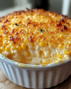 a casserole dish filled with macaroni and cheese on a wooden table