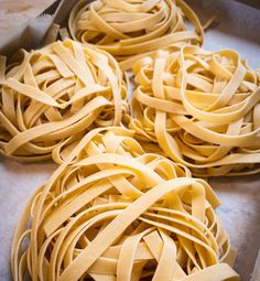 four uncooked pastas sitting on top of a pan