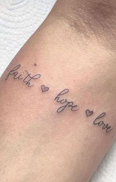 a tattoo saying faith hope and love on the arm