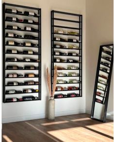 two large mirrors sitting next to each other in front of a wall filled with shelves