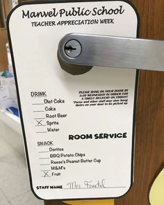 a door handle on a wooden door with an advertise for the public school teacher appreciation week