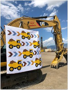 the back end of a construction vehicle with a quilt on it