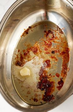 a metal pan filled with food on top of a white counter