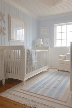 a white crib in a blue and white nursery