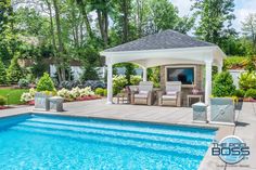 a pool with a gazebo and chairs around it