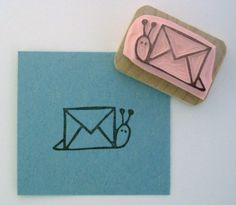 a rubber stamp with an envelope and snail on it next to a piece of paper