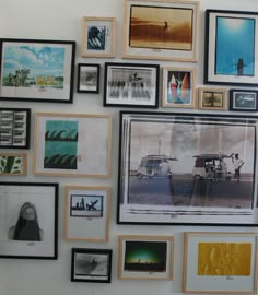 a wall covered in pictures and framed photographs