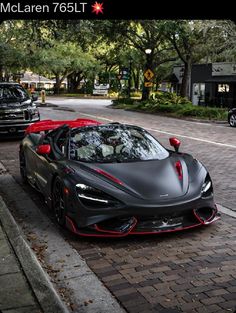 a black and red sports car parked on the street