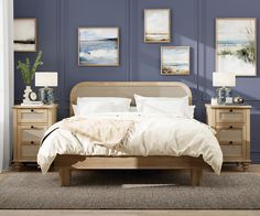 a bedroom scene with focus on the bed and dressers, along with pictures hanging on the wall