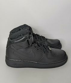 a pair of black nike air force sneakers