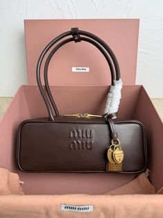 Designer Shoulder Bag With Lock For Travel, Elegant Miu Miu Formal Bags, Luxury Crossbody Shoulder Bag With Interior Key Chain Holder, Luxury Shoulder Bag With Lock, Muimui Bag, Muy Miu Bag, Luxury Crossbody Shoulder Bag With Lock, Miumiu Bags, Luxury Black Shoulder Bag With Multiple Compartments