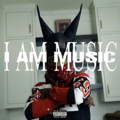 a person wearing a batman mask with the words i am music in front of them