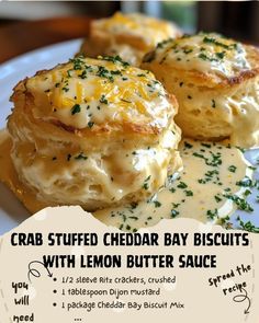 the crab stuffed cheddar bay biscuits with lemon butter sauce are on a white plate