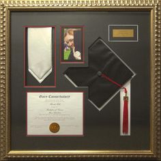 a graduation cap, diploma and other items are on display in a gold framed frame