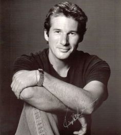 a black and white photo of a man with his arms crossed