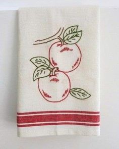 an embroidered dish towel with two cherries on it