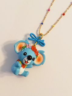 A 🐨 Bear ! How Adorable ! 🐨 How Cute ! 🐨 You need this Awesome Colorful Bear in your life to enhance your Mood and Day ! Just look how Cheerful and Happy this Awesome Koala Bear looks ! Share some Cheer with the Special people that are dear to your 💙  This Adorable Blue Koala is made of light weight Resin and it has been adorned with Bright Beautiful Flowers. *1 1/4 inches long and wide* (Medium Size Charm) What Girl doesn't love Flowers ? It's hanging on a matching 16 inch adjustable Bright Small Beaded Necklace, Bear Pendant, Bear Necklace, Necklace Box, Colourful Necklace, Special People, Koala Bear, Love Flowers, Beaded Chain