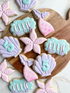 some decorated cookies are on a wooden platter