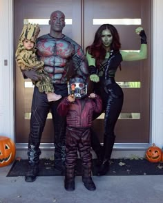 two people and a child dressed up in costumes