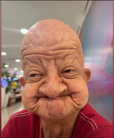 an old man with a silly face and no hair